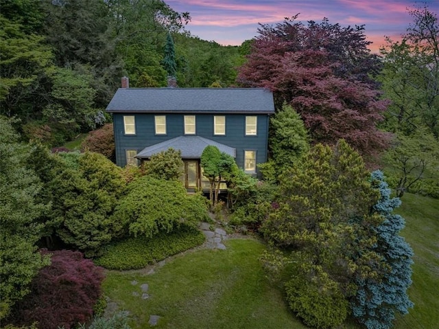 439 Pleasant Hill Rd, Allegheny Twp Wml, PA 15656 - colonial inspired home featuring a chimney, a front lawn, and a view of trees