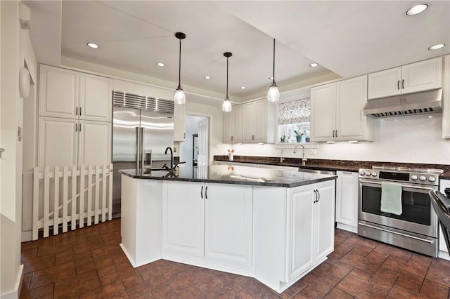 155 Westland Dr, Squirrel Hill, PA 15217 - kitchen with stainless steel range with gas cooktop, under cabinet range hood, white cabinets, a center island with sink, and recessed lighting