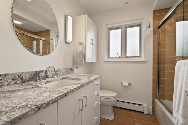 155 Westland Dr, Squirrel Hill, PA 15217 - full bathroom with baseboard heating, toilet, vanity, wood finished floors, and enclosed tub / shower combo