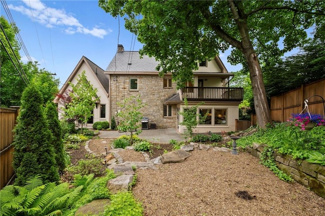 155 Westland Dr, Squirrel Hill, PA 15217 - rear view of house with stone siding, a balcony, a patio, a chimney, and stucco siding