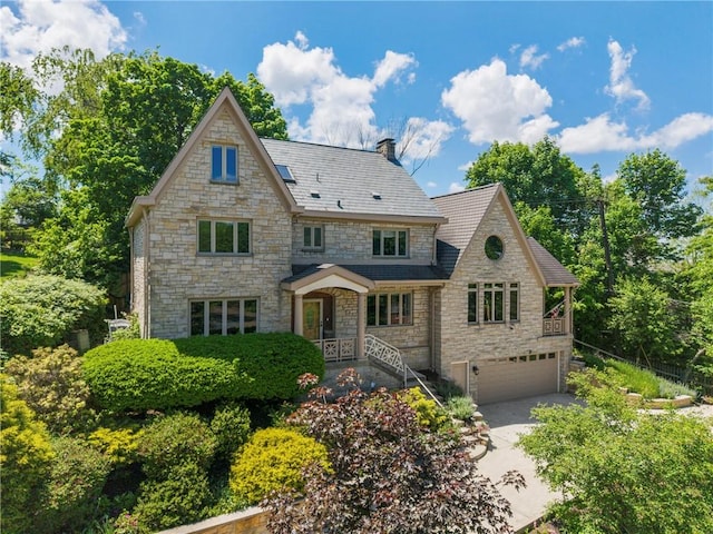 155 Westland Dr, Squirrel Hill, PA 15217 - view of front of house featuring stone siding, a garage, concrete driveway, a high end roof, and a chimney