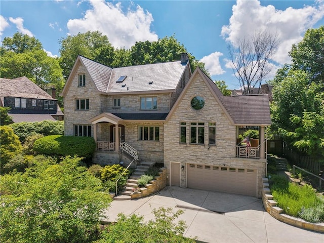 155 Westland Dr, Squirrel Hill, PA 15217 - view of front of house featuring stone siding, concrete driveway, an attached garage, and a high end roof