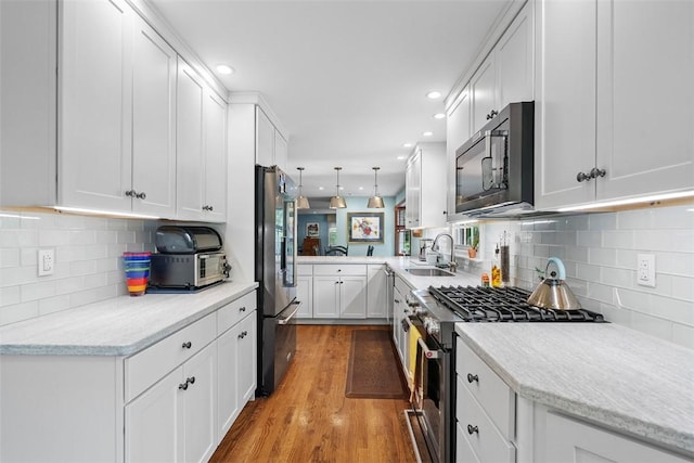111 Maple Dr, Pine Twp Nal, PA 15090 - kitchen with stainless steel appliances, a sink, backsplash, white cabinets, and recessed lighting
