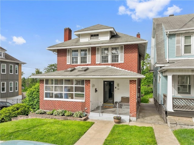 245 Martsolf Ave, West View, PA 15229 - american foursquare style home with brick siding, a chimney, a porch, a front lawn, and a shingled roof