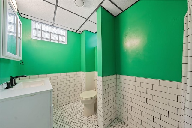 245 Martsolf Ave, West View, PA 15229 - bathroom featuring toilet, vanity, tile walls, a wainscoted wall, and tile patterned floors