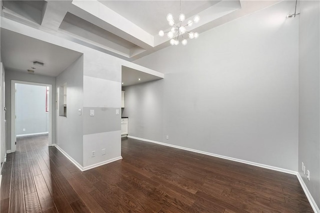 130 S 22nd St Unit 2C, South Side, PA 15203 - spare room with baseboards, a chandelier, dark wood-style flooring, and a raised ceiling