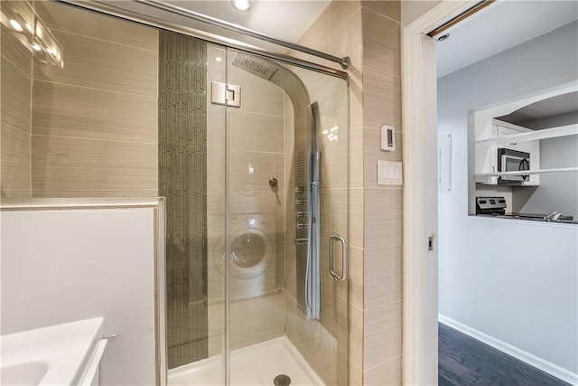 130 S 22nd St Unit 2C, South Side, PA 15203 - bathroom with a shower stall, vanity, and wood finished floors