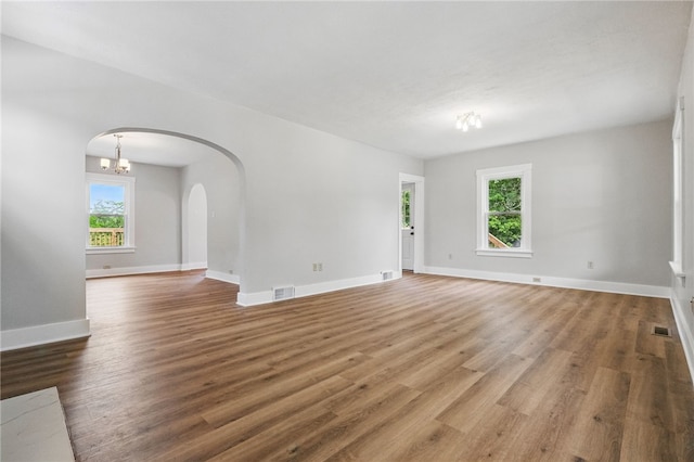5241 Clarwin Ave, Ross Twp, PA 15229 - empty room with arched walkways, wood finished floors, and baseboards