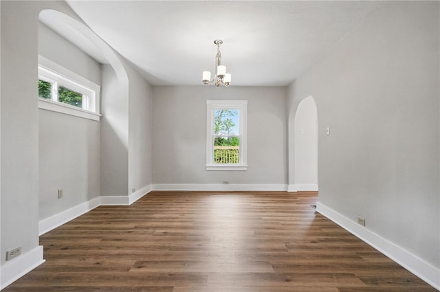 5241 Clarwin Ave, Ross Twp, PA 15229 - empty room featuring arched walkways, plenty of natural light, a chandelier, and baseboards
