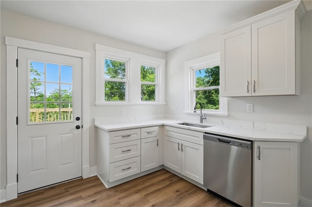 5241 Clarwin Ave, Ross Twp, PA 15229 - kitchen with stainless steel dishwasher, a sink, wood finished floors, white cabinets, and light stone counters
