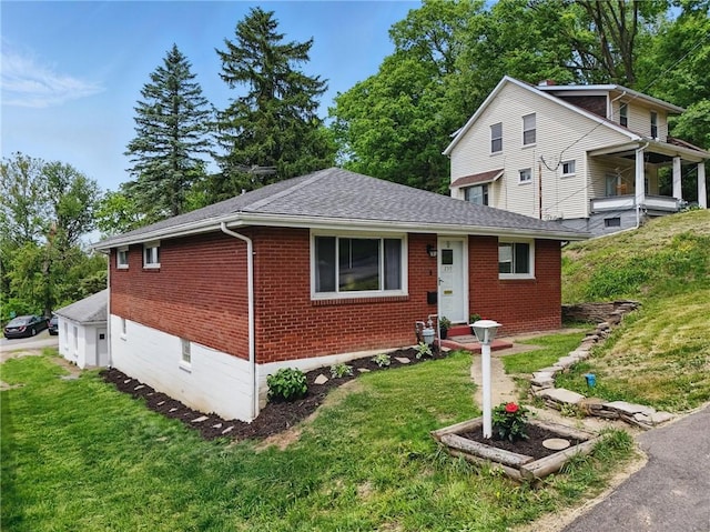 259 Allison Ave, Emsworth, PA 15202 - view of front facade with brick siding, a front yard, and a shingled roof