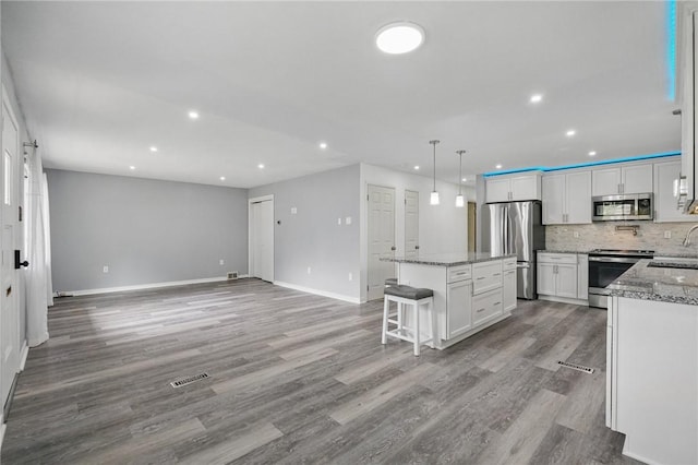 259 Allison Ave, Emsworth, PA 15202 - kitchen with appliances with stainless steel finishes, a kitchen island, a sink, recessed lighting, and white cabinetry
