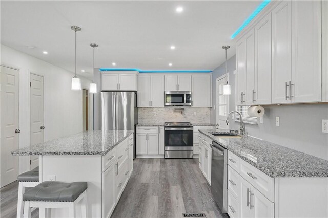 259 Allison Ave, Emsworth, PA 15202 - kitchen featuring stainless steel appliances, a sink, wood finished floors, white cabinetry, and recessed lighting