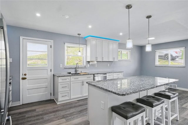 259 Allison Ave, Emsworth, PA 15202 - kitchen featuring a sink, stainless steel dishwasher, dark wood finished floors, light stone countertops, and white cabinetry