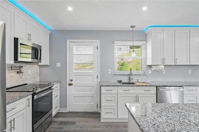 259 Allison Ave, Emsworth, PA 15202 - kitchen with appliances with stainless steel finishes, a sink, white cabinetry, tasteful backsplash, and dark wood finished floors