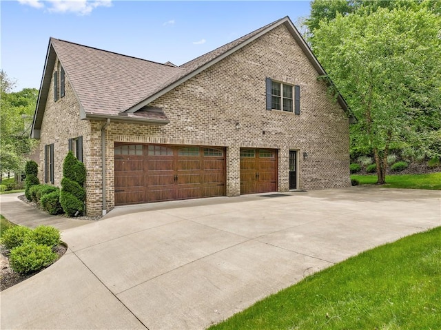 321 Ivy Dr, Pine Twp Nal, PA 15044 - view of side of property featuring brick siding, concrete driveway, roof with shingles, and an attached garage