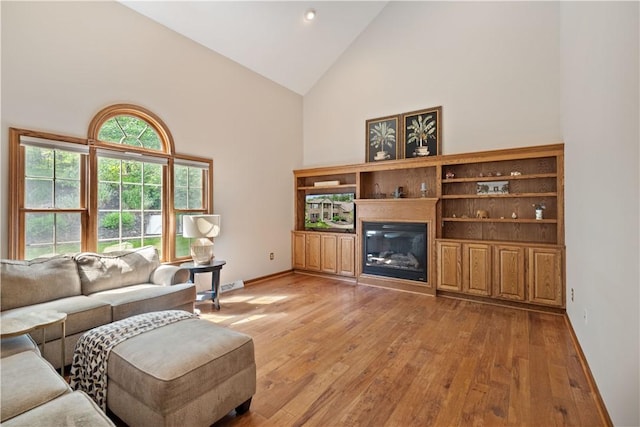 321 Ivy Dr, Pine Twp Nal, PA 15044 - living room with high vaulted ceiling, light wood-type flooring, and a glass covered fireplace