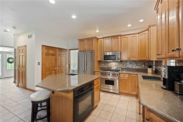 321 Ivy Dr, Pine Twp Nal, PA 15044 - kitchen featuring high quality appliances, light tile patterned flooring, tasteful backsplash, recessed lighting, and a center island with sink