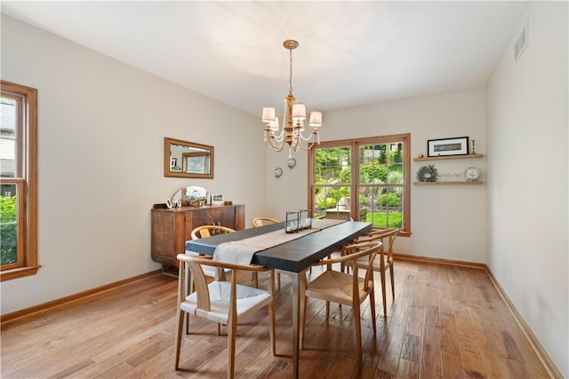 321 Ivy Dr, Pine Twp Nal, PA 15044 - dining room with a chandelier, light wood-type flooring, and baseboards
