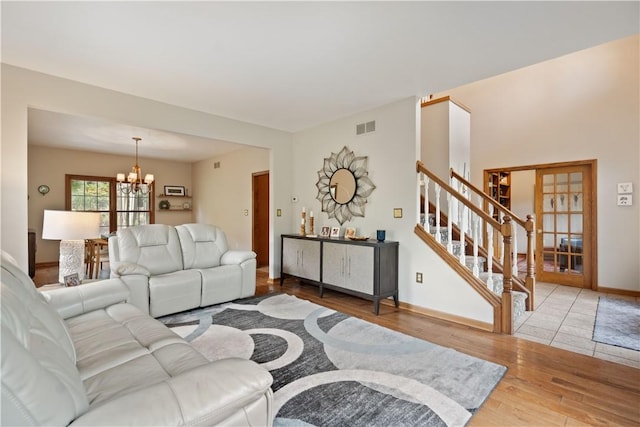 321 Ivy Dr, Pine Twp Nal, PA 15044 - living area featuring a chandelier, wood finished floors, stairs, and french doors