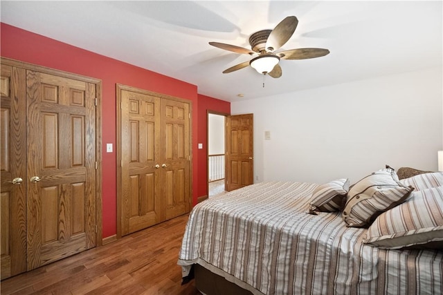 321 Ivy Dr, Pine Twp Nal, PA 15044 - bedroom with wood finished floors, a ceiling fan, and multiple closets