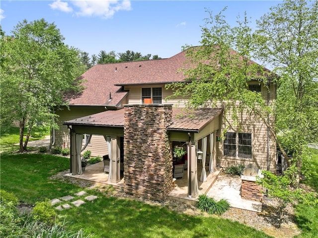 321 Ivy Dr, Pine Twp Nal, PA 15044 - back of house featuring a patio area, a lawn, metal roof, a standing seam roof, and roof with shingles