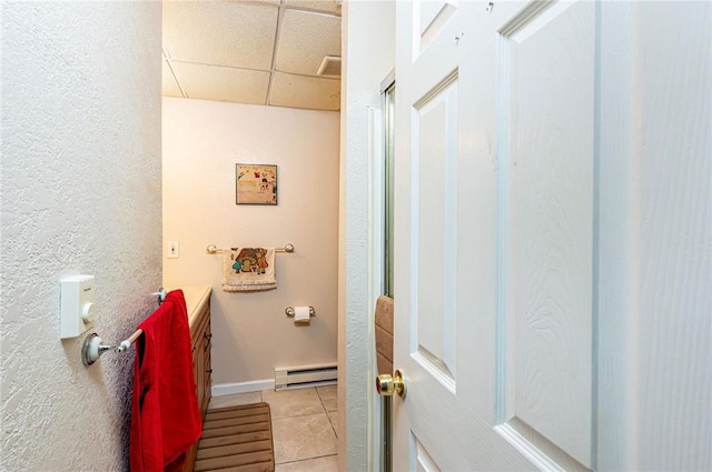 34 Max St, Hempfield Twp Wml, PA 15601 - bathroom with baseboard heating, a drop ceiling, tile patterned floors, vanity, and baseboards