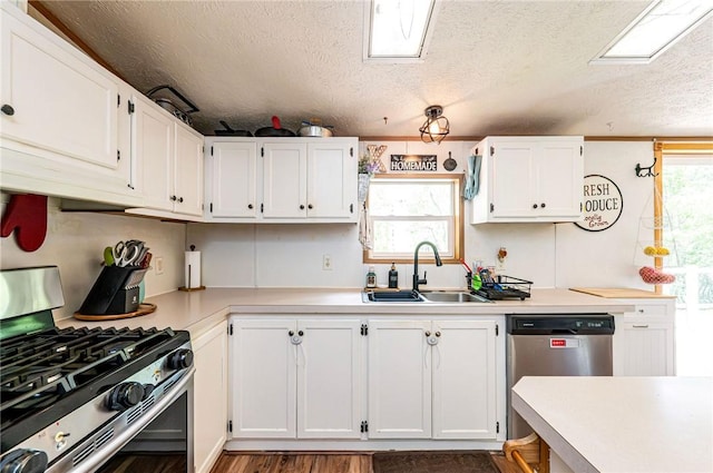 34 Max St, Hempfield Twp Wml, PA 15601 - kitchen with appliances with stainless steel finishes, a sink, white cabinets, light countertops, and a textured ceiling