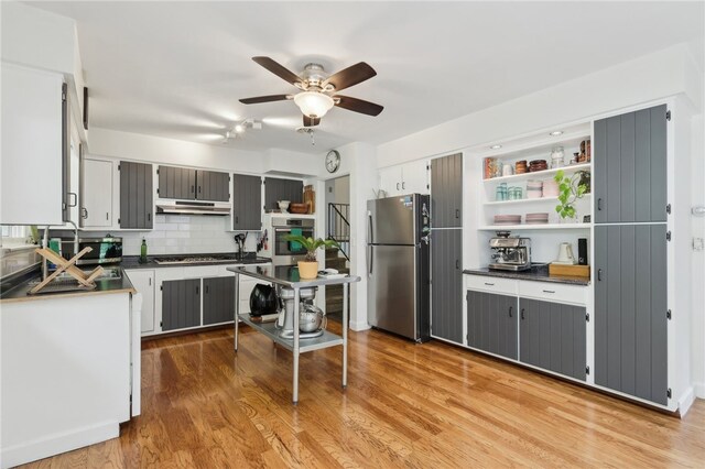 643 Croyland Ave, Indiana Boro, PA 15701 - kitchen featuring stainless steel appliances, under cabinet range hood, dark countertops, a ceiling fan, and decorative backsplash