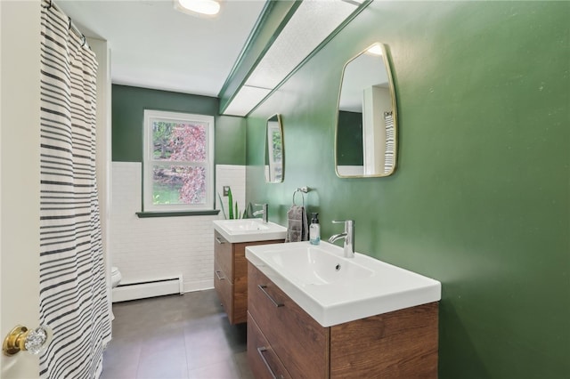 643 Croyland Ave, Indiana Boro, PA 15701 - full bath with baseboard heating, tile walls, wainscoting, two vanities, and toilet