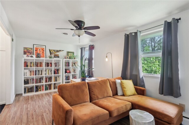 643 Croyland Ave, Indiana Boro, PA 15701 - living area featuring a ceiling fan, light wood-style flooring, baseboards, and a baseboard heating unit