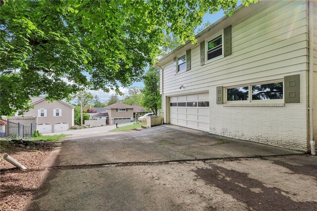 643 Croyland Ave, Indiana Boro, PA 15701 - view of side of home with a garage, brick siding, driveway, and a residential view