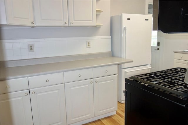 537 E Chestnut St E, Washington Boro, PA 15301 - kitchen featuring gas stove, light countertops, white cabinetry, open shelves, and light wood-type flooring