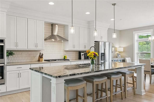 349 Azalea Dr, Peters Twp, PA 15367 - kitchen with wall chimney range hood, appliances with stainless steel finishes, light wood-style flooring, white cabinetry, and recessed lighting