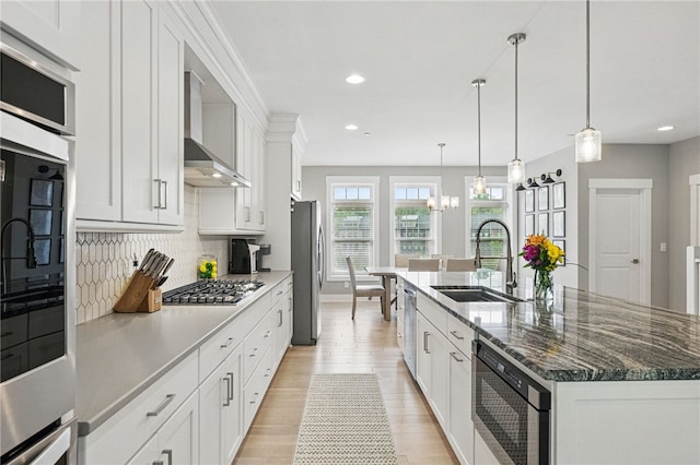 349 Azalea Dr, Peters Twp, PA 15367 - kitchen with stainless steel appliances, a sink, wall chimney range hood, tasteful backsplash, and a spacious island