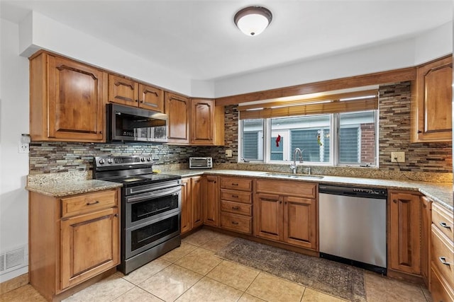 920 Maple Ave, Castle Shannon, PA 15234 - kitchen with stainless steel appliances, a sink, backsplash, and brown cabinetry
