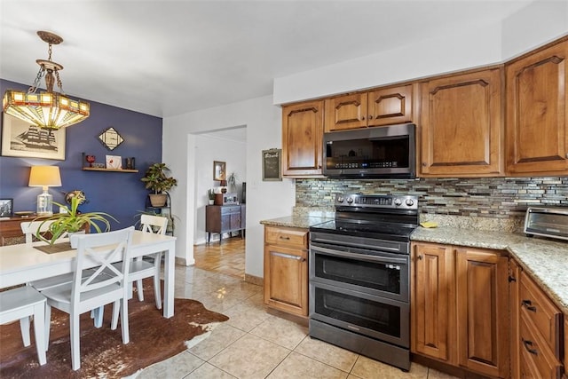 920 Maple Ave, Castle Shannon, PA 15234 - kitchen featuring appliances with stainless steel finishes, decorative backsplash, brown cabinets, and light tile patterned flooring