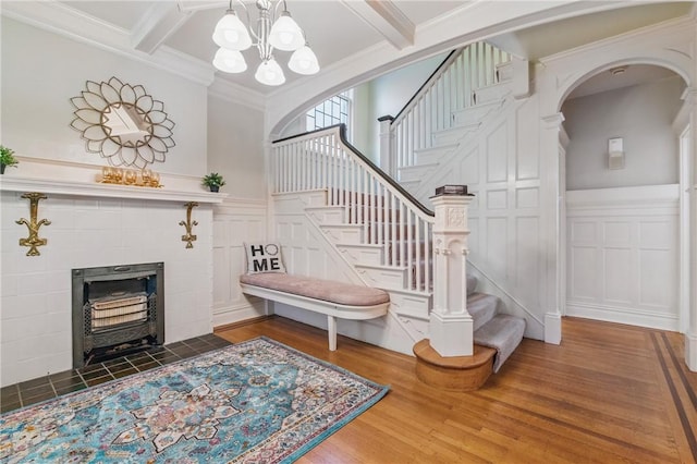 1800 Wightman St, Squirrel Hill, PA 15217 - staircase with a decorative wall, a chandelier, wood finished floors, beamed ceiling, and a wainscoted wall