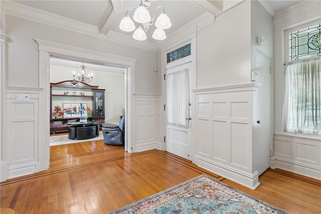 1800 Wightman St, Squirrel Hill, PA 15217 - foyer entrance featuring a chandelier, a decorative wall, healthy amount of natural light, wood-type flooring, and wainscoting