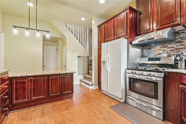 1800 Wightman St, Squirrel Hill, PA 15217 - kitchen with stainless steel gas range oven, white refrigerator with ice dispenser, under cabinet range hood, reddish brown cabinets, and tasteful backsplash