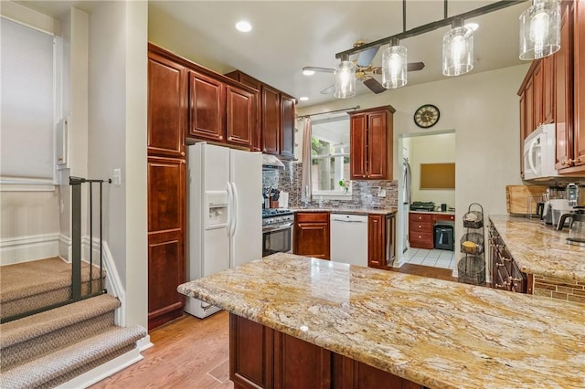 1800 Wightman St, Squirrel Hill, PA 15217 - kitchen featuring white appliances, decorative backsplash, light stone countertops, a peninsula, and recessed lighting