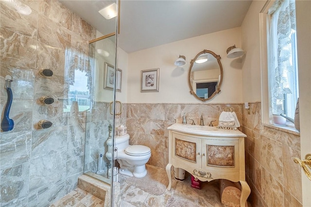 3098 Clay Pike St, Sewickley Twp, PA 15637 - full bathroom with tile walls, a stall shower, vanity, toilet, and wainscoting