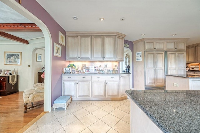 3098 Clay Pike St, Sewickley Twp, PA 15637 - kitchen with arched walkways, dark stone counters, light tile patterned floors, recessed lighting, and decorative backsplash