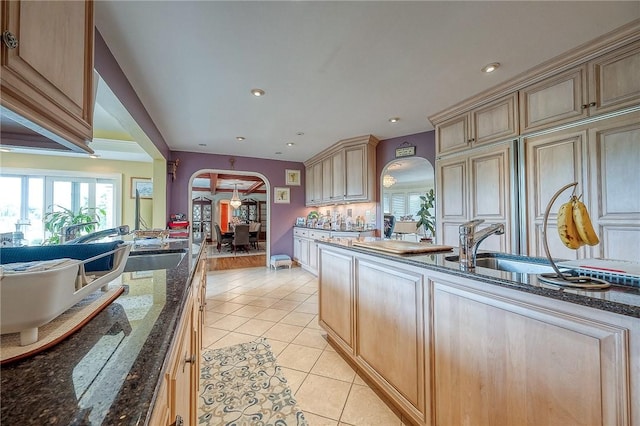 3098 Clay Pike St, Sewickley Twp, PA 15637 - kitchen featuring arched walkways, light tile patterned floors, dark stone countertops, cream cabinetry, and recessed lighting