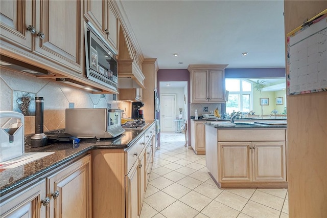 3098 Clay Pike St, Sewickley Twp, PA 15637 - kitchen with appliances with stainless steel finishes, backsplash, light tile patterned flooring, dark stone counters, and light brown cabinetry