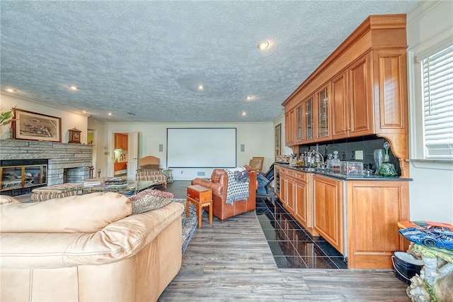 3098 Clay Pike St, Sewickley Twp, PA 15637 - indoor wet bar with a fireplace, plenty of natural light, recessed lighting, crown molding, and a textured ceiling