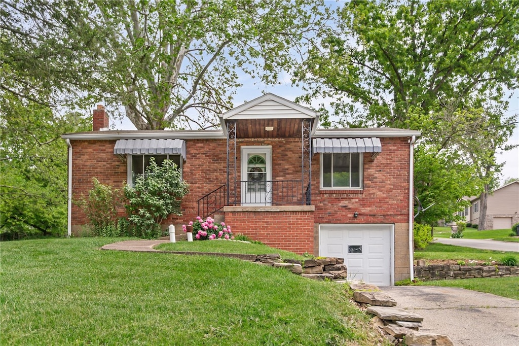 1332 Rte 519, North Strabane, PA 15330 - view of front of home featuring asphalt driveway, a front yard, an attached garage, and a chimney