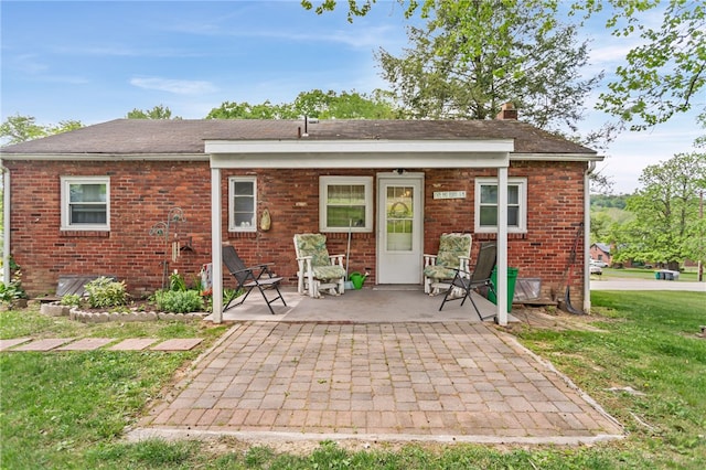 1332 Rte 519, North Strabane, PA 15330 - back of property featuring brick siding, a patio area, a lawn, and a chimney