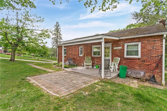 1332 Rte 519, North Strabane, PA 15330 - rear view of property featuring a patio area, brick siding, a lawn, and a chimney