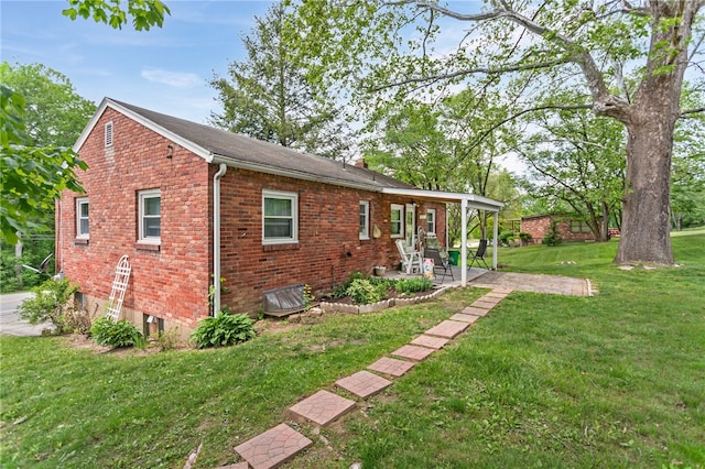 1332 Rte 519, North Strabane, PA 15330 - view of home's exterior with a lawn, a patio area, and brick siding